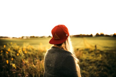Woman In Gray Cardigan And Red Snapback Cap photo