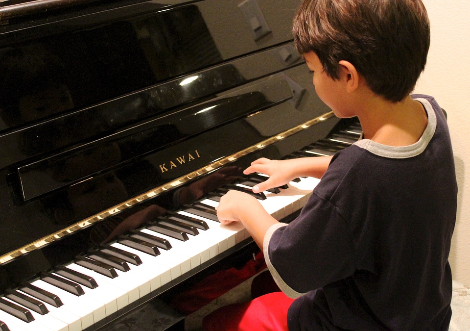Learning piano lesson child playing piano