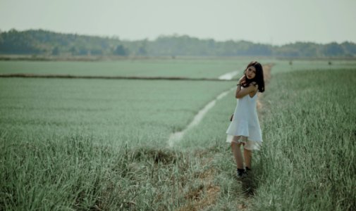 Woman In White Sleeveless Dress On Grass Field photo