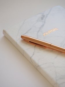 Gold Pen On Journal Book