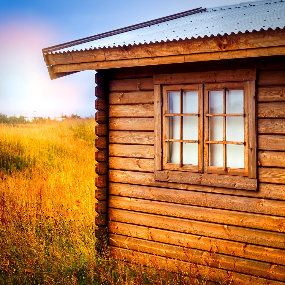 Brown Wooden Cottage At The Field During Day