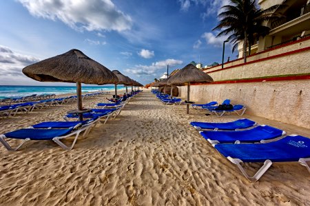 Blue And White Outdoor Chaise Lounges And Nipa Hut Beside Seashore photo