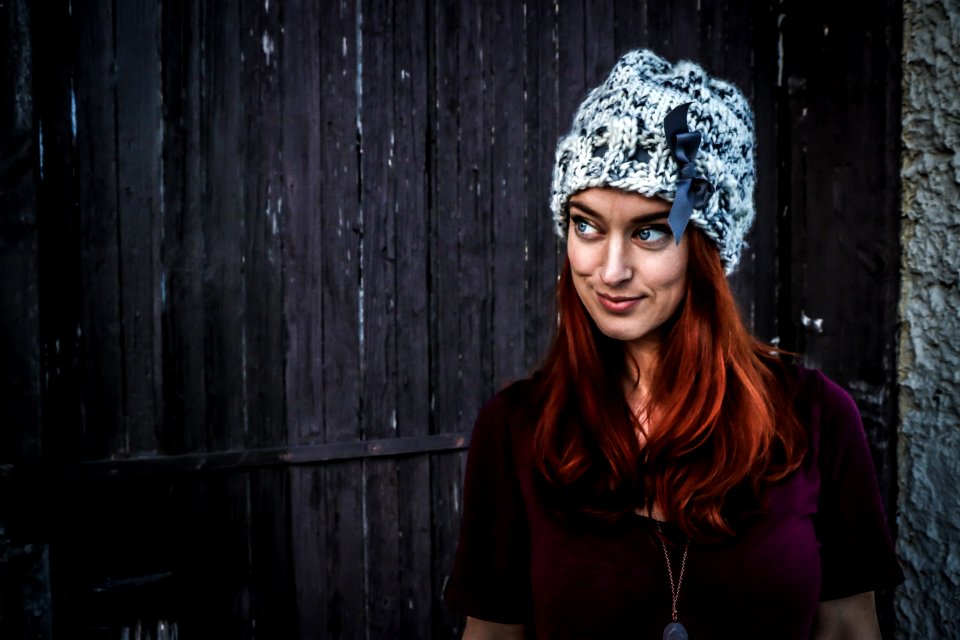 Woman Wearing Maroon Short-sleeved Shirt And White And Grey Knit Cap photo