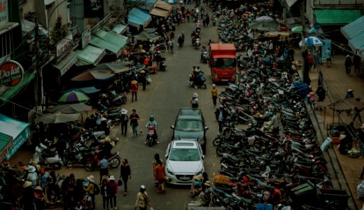 Group Of People Walking Through Market