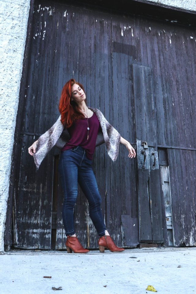Woman In Red Tank Top With Brown Scarf Standing Near Black Wooden Door Closed