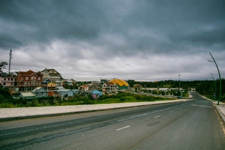 Village Beside Road Under Cloudy Sky photo