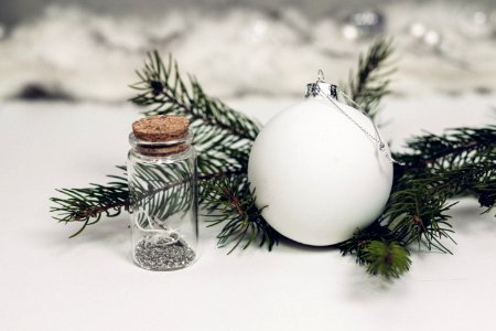 Selective Focus Photography Of White Christmas Bauble Beside Bottle With Cork Lid photo