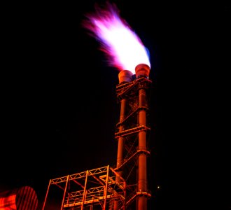 Low Angle View Of Illuminated Tower Against Sky At Night photo