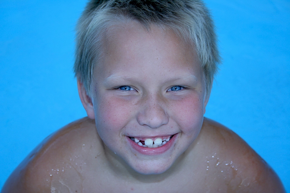 Laughing kid swimming