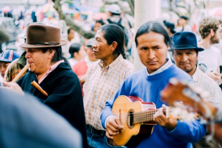 Man Playing Acoustic Guitar Beside People During Daytime