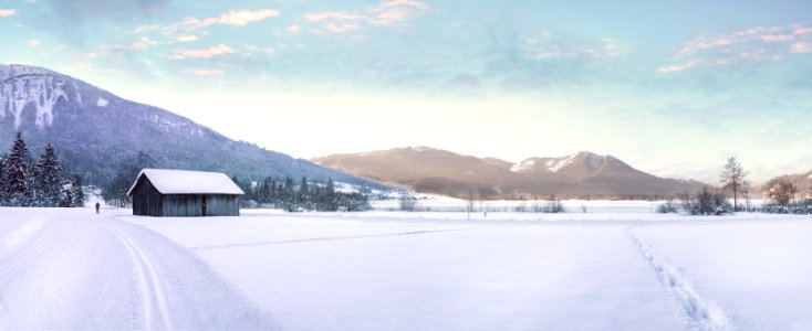 Snow Covered Landscape Against Mountain Range photo