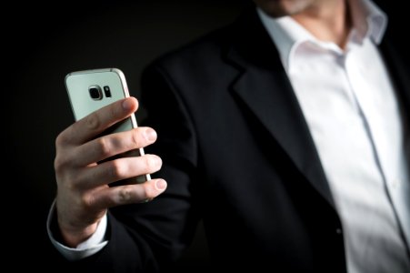 Close-up Of Man Using Mobile Phone photo