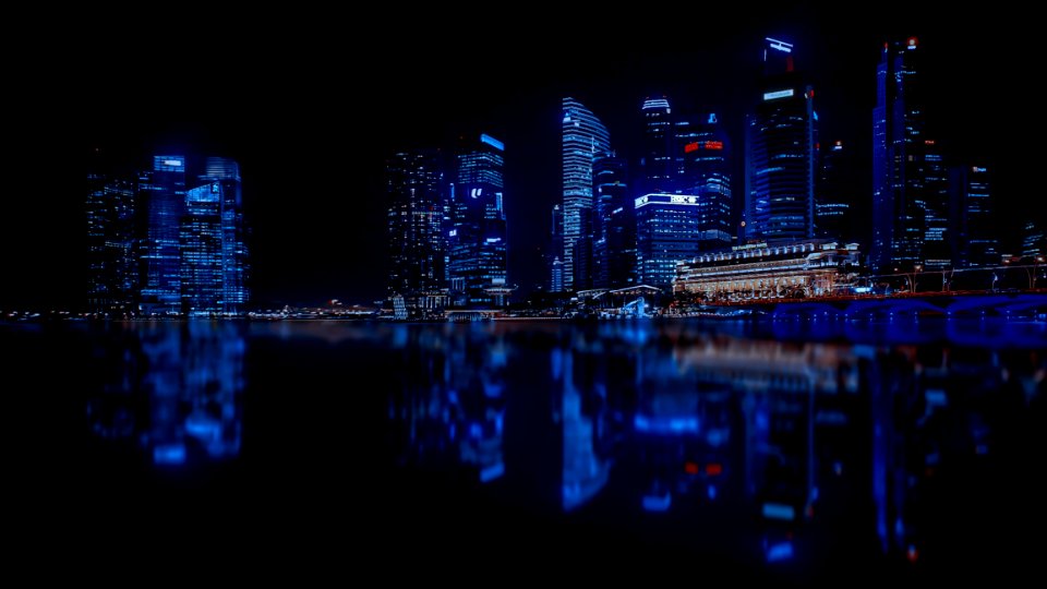 Illuminated Cityscape Against Blue Sky At Night photo