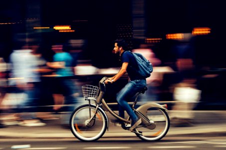 Man Riding Bicycle On City Street