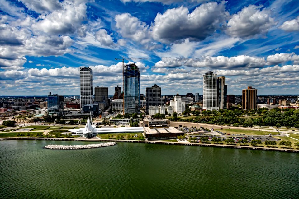 City At Waterfront Against Cloudy Sky