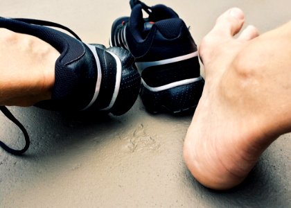 Close-up Of Man Wearing Shoes
