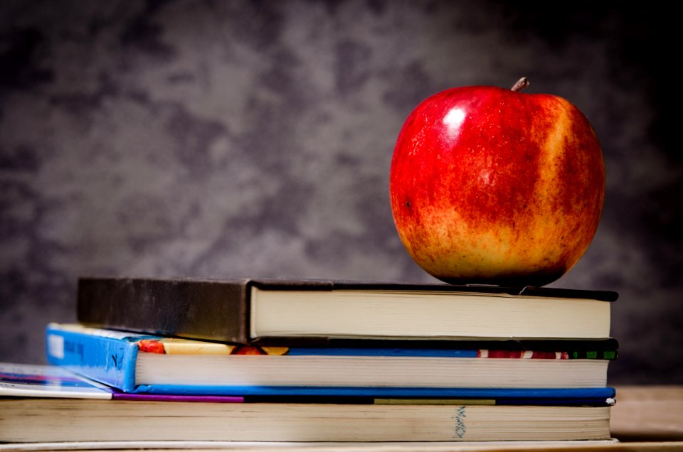 Close-up Of Apple On Top Of Books