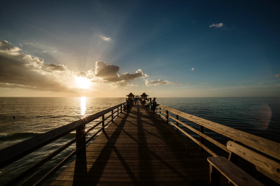 Close-up Of Bridge Over Sea At Sunset