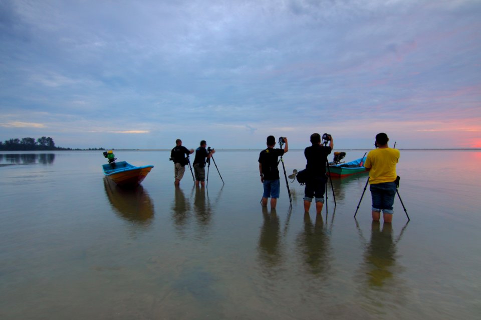 People On Beach Against Sky
