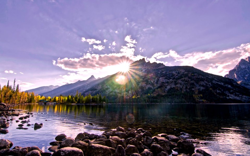 Scenic View Of Lake By Mountains Against Sky At Night