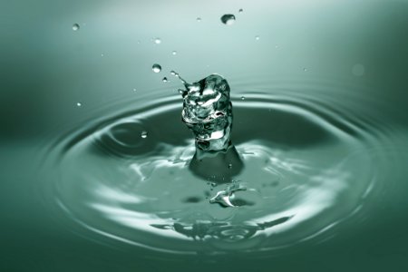 Close-up Of Drop Splashing In Water photo