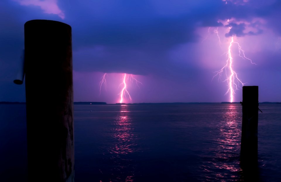 Lightning Over Sea Against Storm Clouds