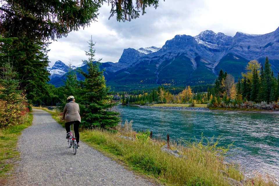Rear View Of Woman Walking On Mountain Road