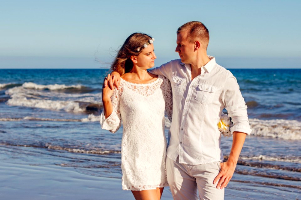 Couple Looking At Each Other Beside Beach