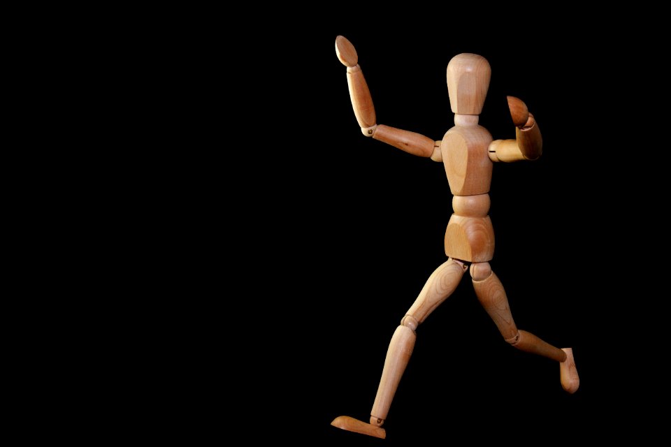 Timelapse Photography Of Brown Wooden Puppet Running On A Black Screen