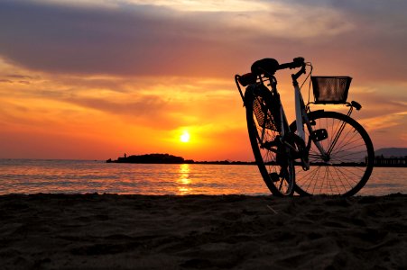 White Hard Tail Bicycle On Brown Beach Sand During Sunsets photo