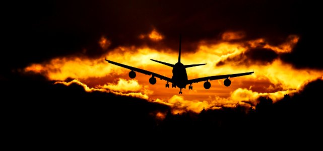 Airplane Silhouette On Air During Sunset photo