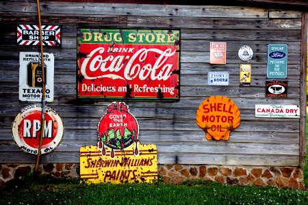 Drug Store Drink Coca Cola Signage On Gray Wooden Wall photo
