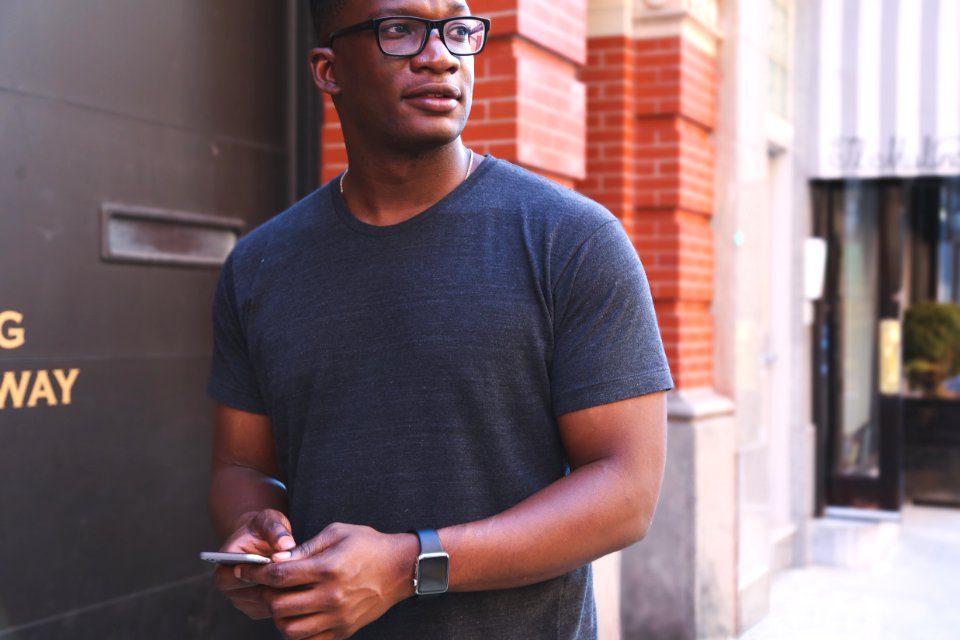 Man In Gray T-shirt Near Black Metal Wall photo