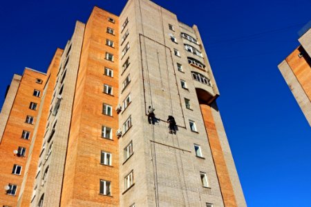 Person Hanging On A High Rise Building photo