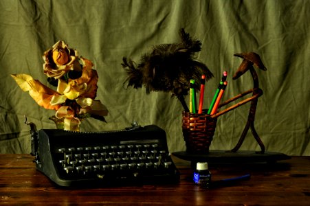 Black Typwriter Near Brown Wicker Pencil Cup photo