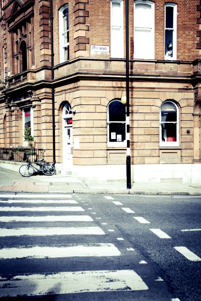 Black Bicycle Parked On The Edge Of A Street During Daytime