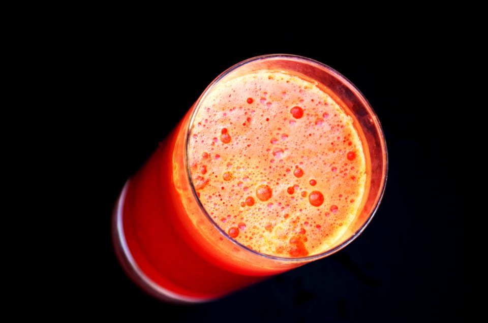 Glass Of Orange Liquid In Close Up Photography photo