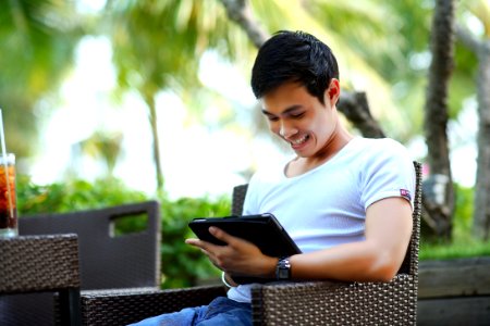 Man In White Shirt Using Tablet Computer Shallow Focus Photography