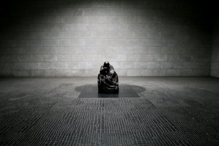 Man In Monk Suit Sitting photo