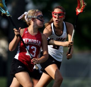 Woman And Girl Playing Lacrosse photo