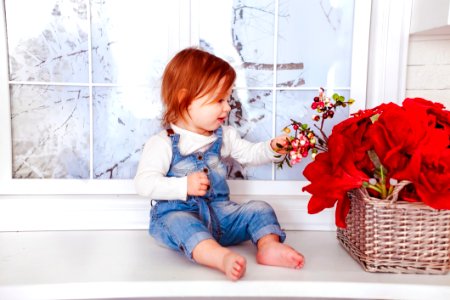 Kids Blue Denim Jumper Sitting On White Wooden Side Table photo