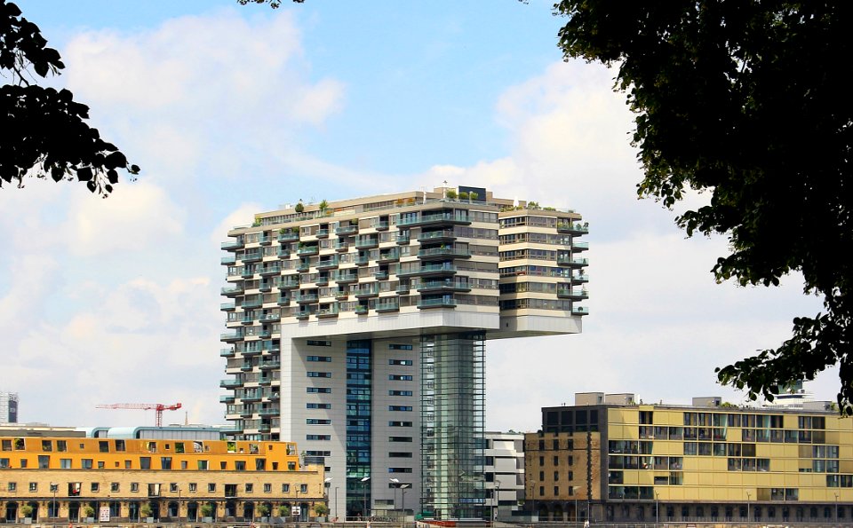 White And Gray Concrete Building Under Cloudy Blue Sky During Daytime photo