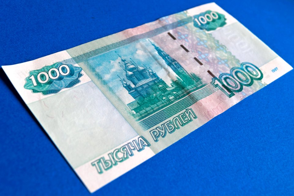 1000 Banknote On Top Of Blue Surface