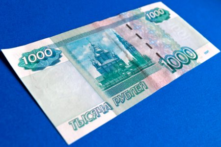 1000 Banknote On Top Of Blue Surface