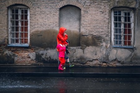 Children And Man Walking On A Sidewalk During Daytime photo