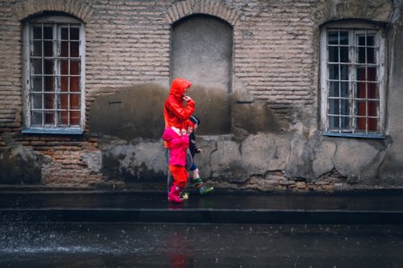 Children And Man Walking On A Sidewalk During Daytime