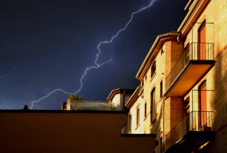 Yellow Building Under Thunderstorm In Black Sky photo