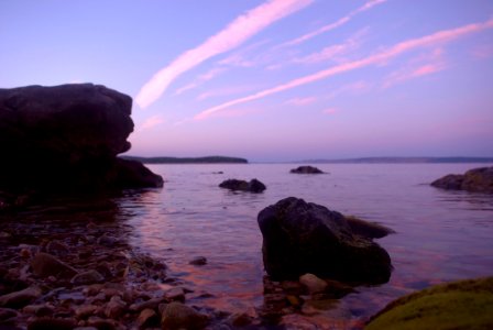 Rock Formation On Body Of Water Under Altostratus Clouds photo