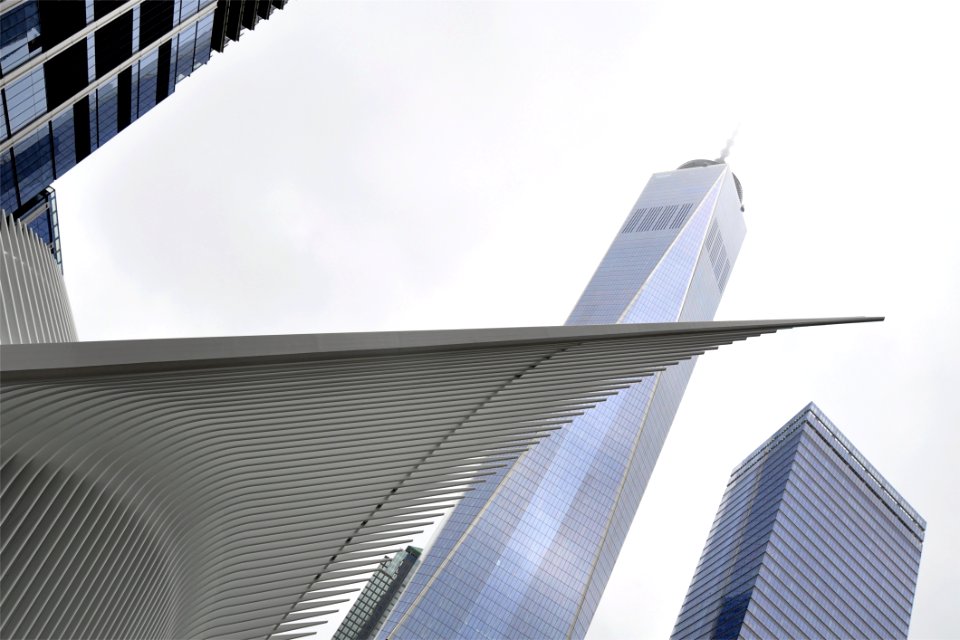 White Concrete Tower Shape Building Near Building During Daytime