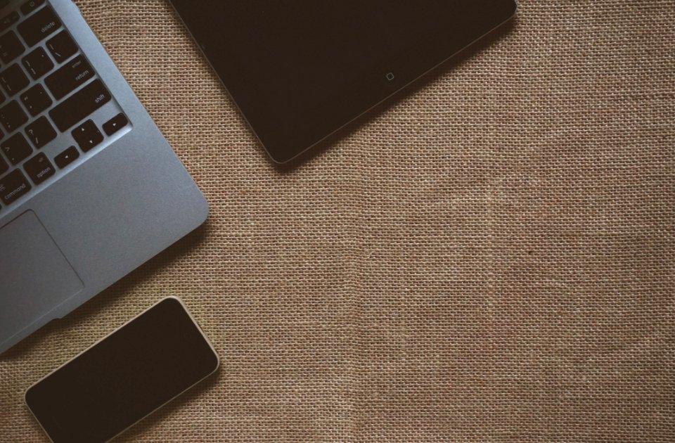 Black Ipad Near Macbook On Brown Textile